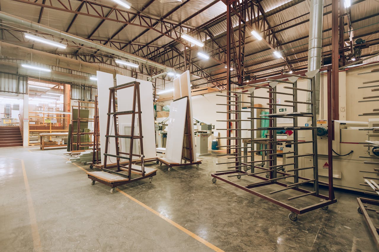 A large, well-lit industrial factory interior showcasing machinery and storage solutions.